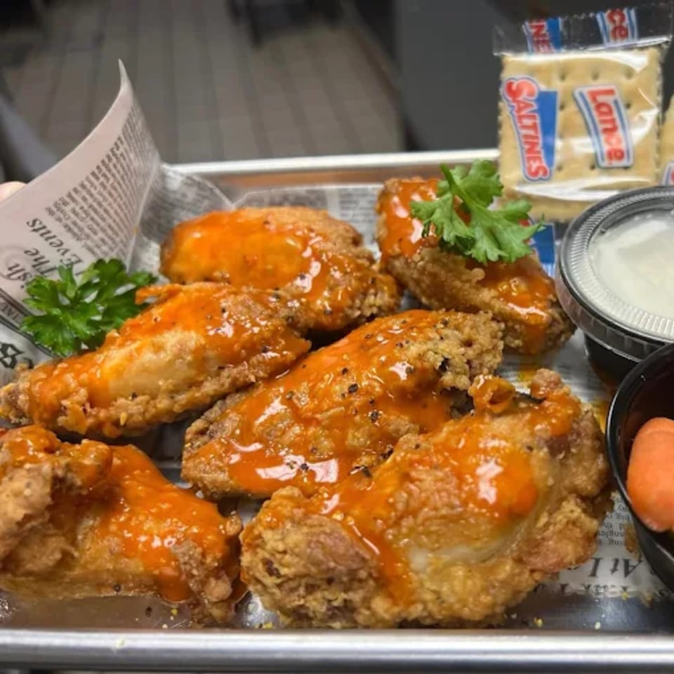 Cajun Crab's fried chicken wings, drizzled with orange sauce, served with crackers and dipping sauce.
