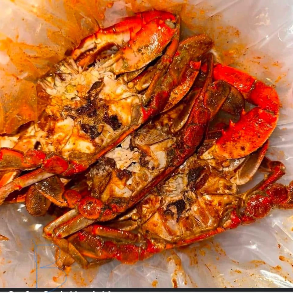 Cajun Crab's delicious crab legs and claws, coated in rich, spicy seasoning, served in a plastic bag.
